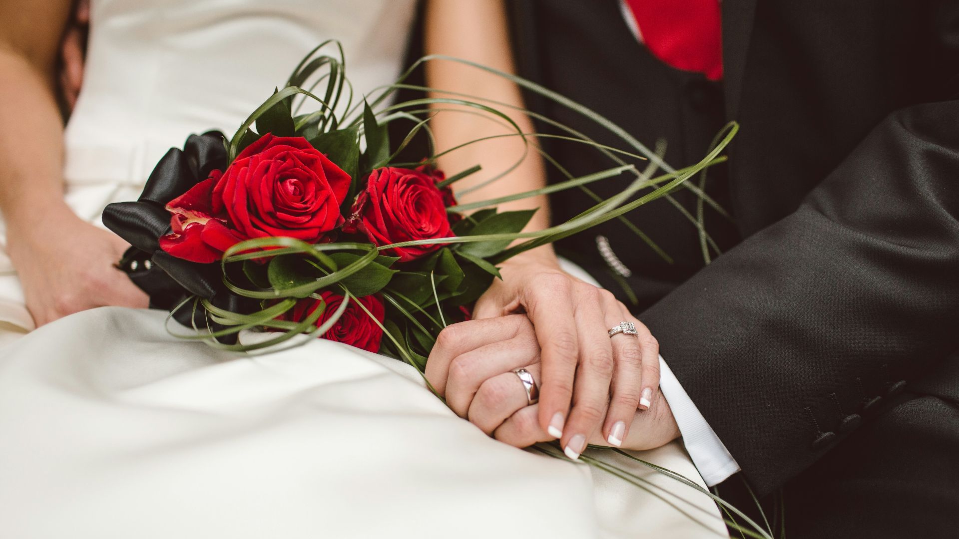 man holding red flowers