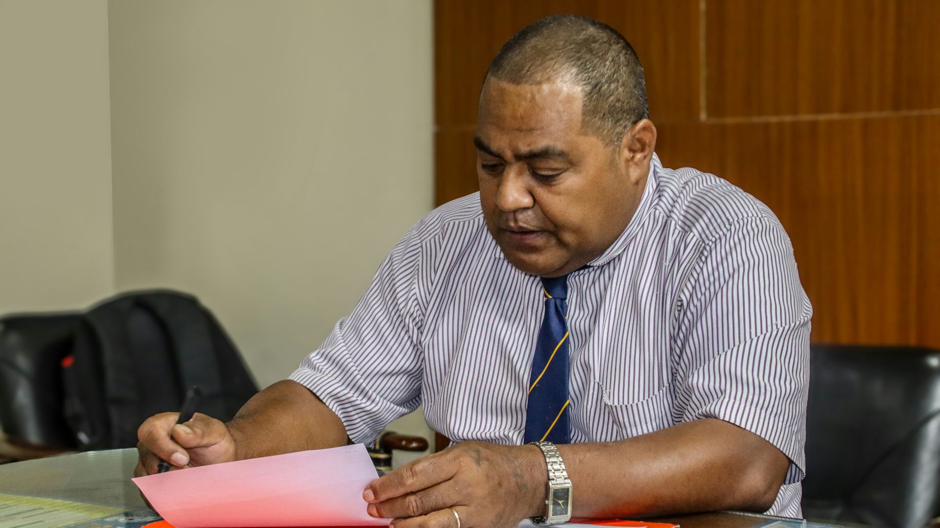a man sitting at a table with papers in front of him