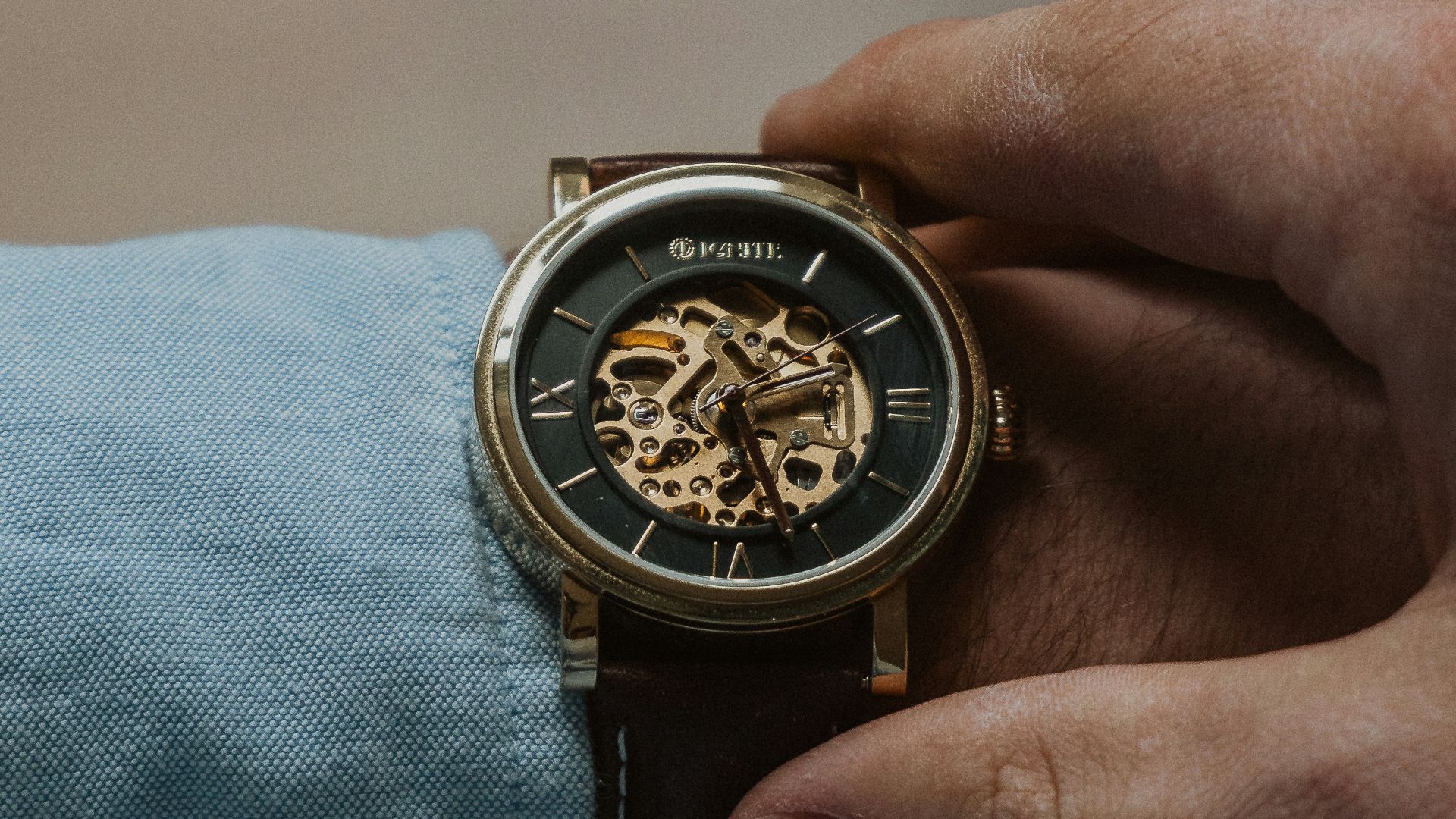 person wearing silver and gold chronograph watch