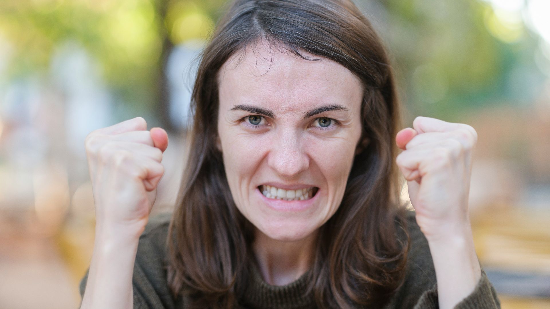 a woman holding her fists up in the air
