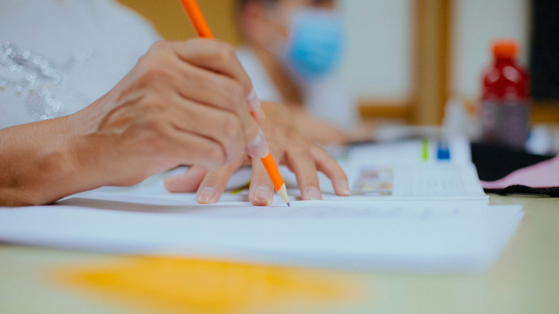 person writing on white paper