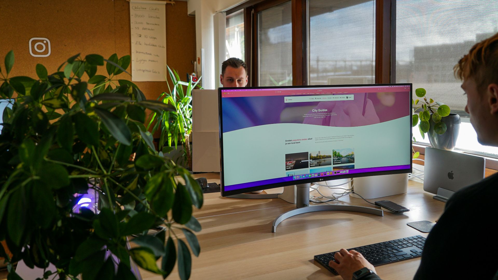 a man sitting at a desk in front of a computer monitor