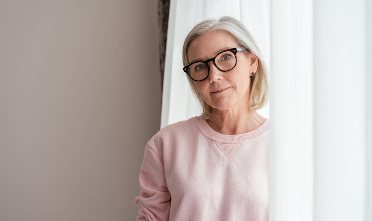 Elderly Woman in Pink Sweater Wearing Eyeglasses