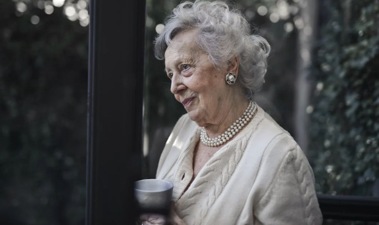 Woman Wearing White Top While Holding Ceramic Mug