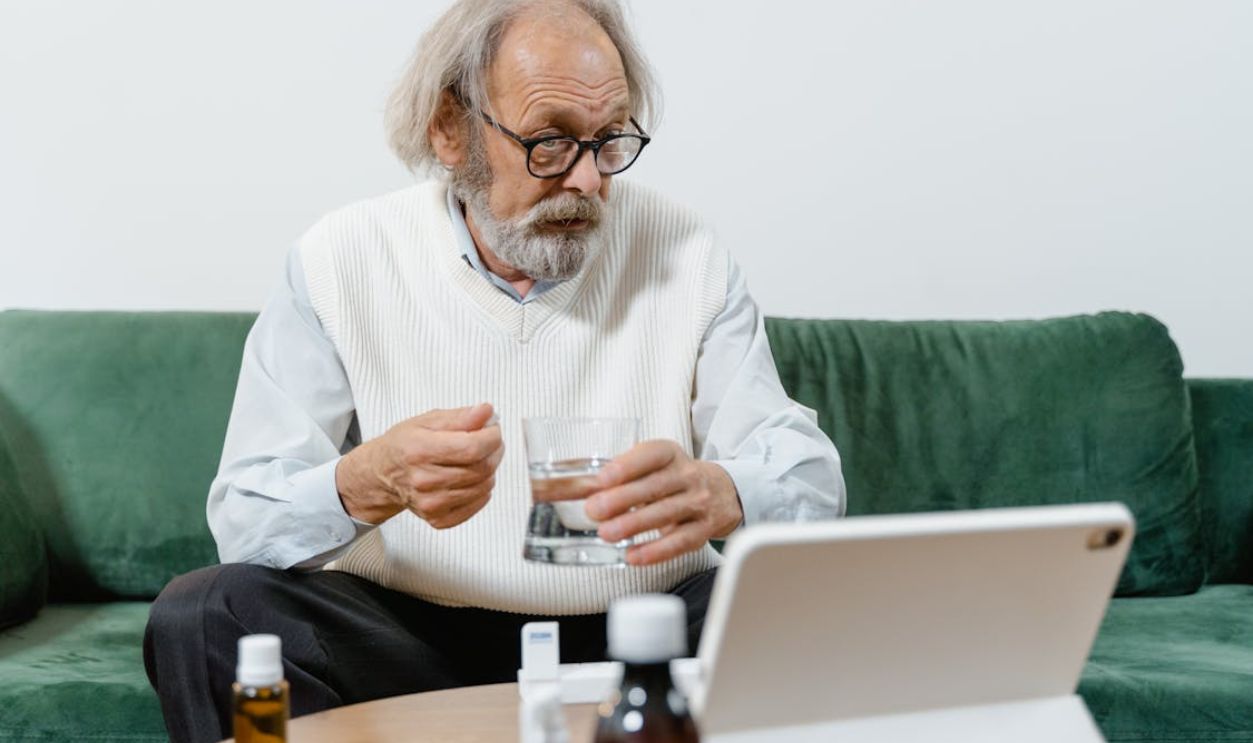 Elderly Man Holding Glass of Water