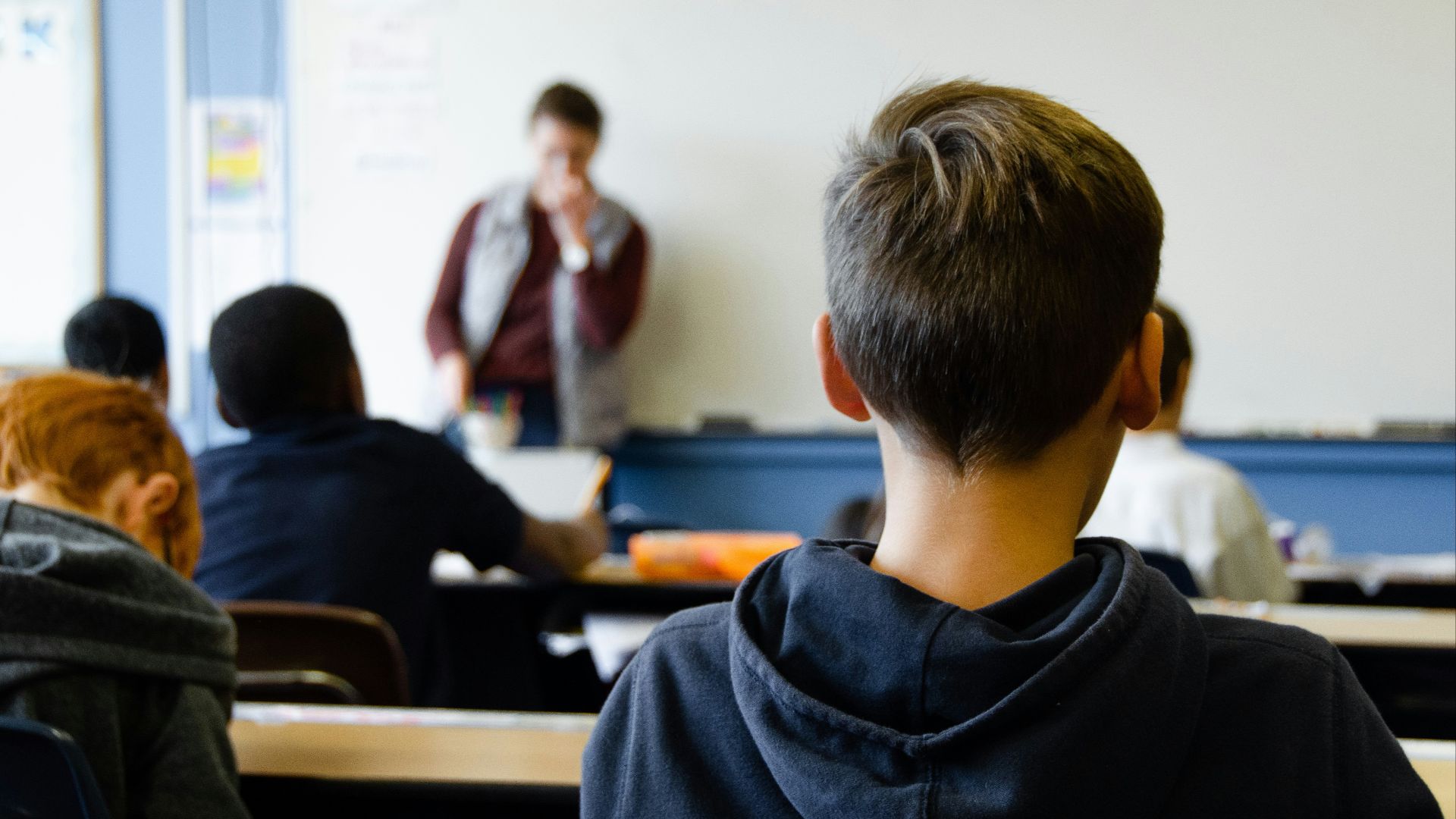boy in black hoodie sitting on chair