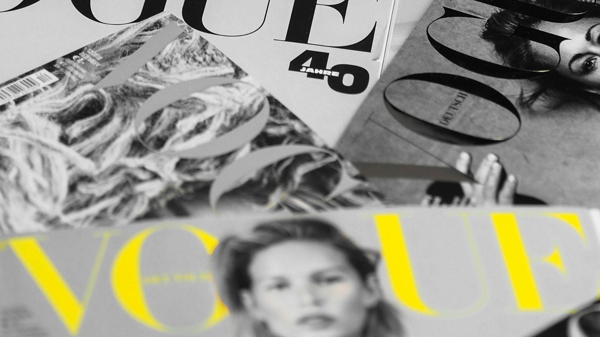 a pile of magazines sitting on top of a bed