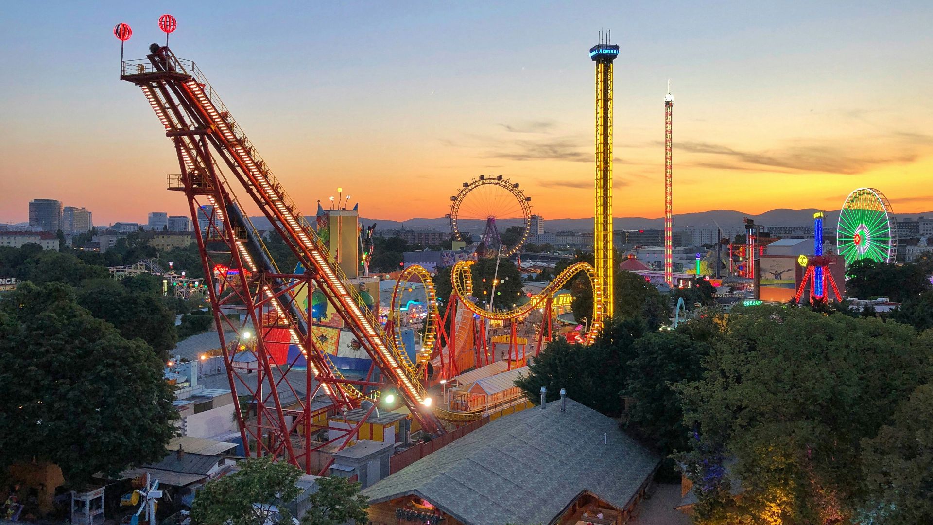 red and yellow crane near building during sunset
