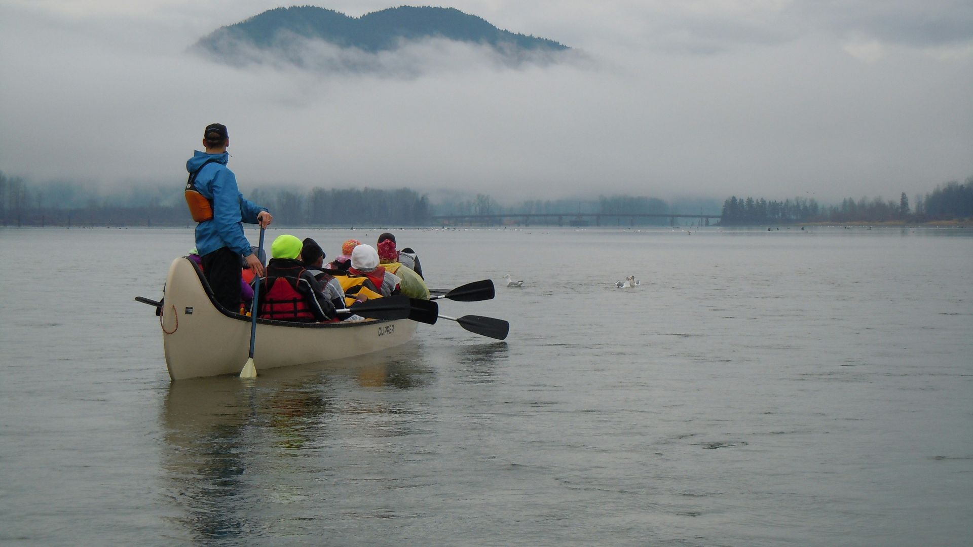 a group of people in a canoe on a lake