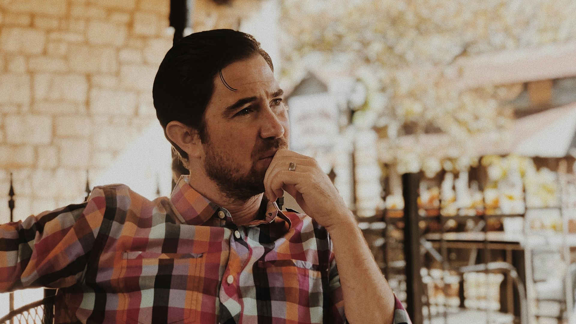 man in red and black plaid dress shirt
