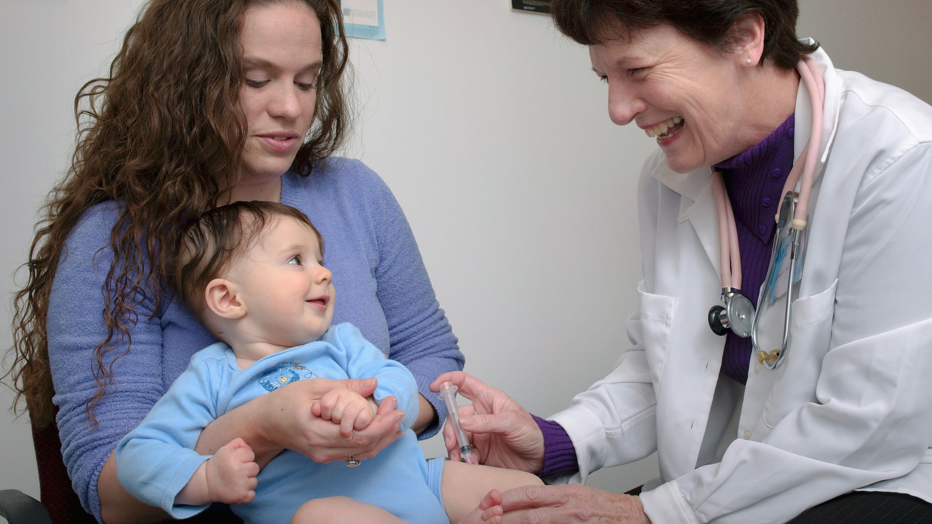 a young child is being examined by a doctor