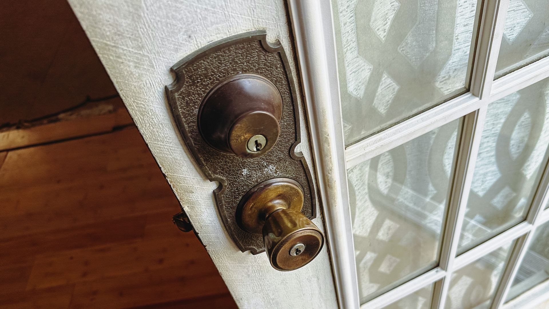 a close up of a door handle on a glass door