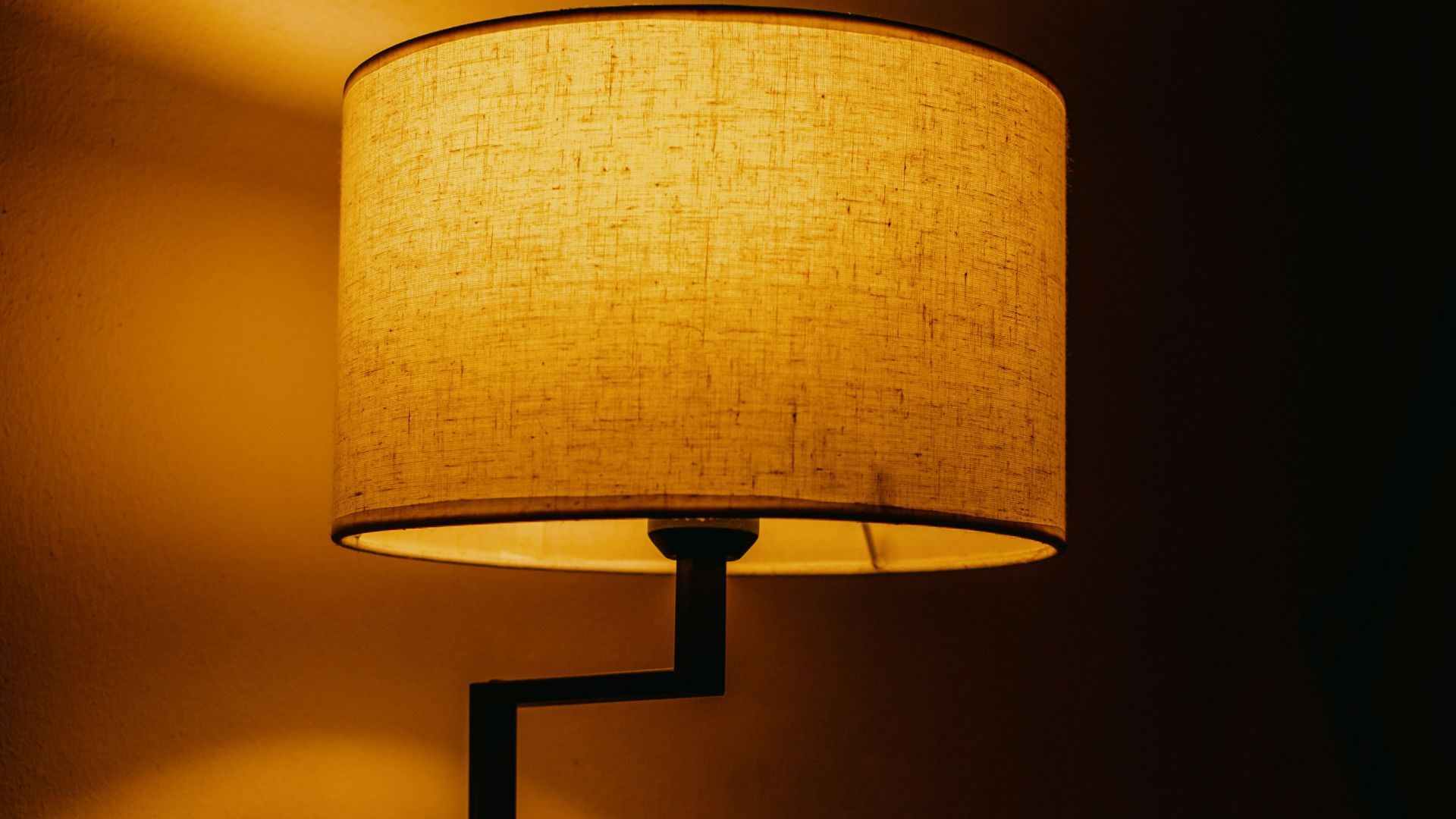 A lamp sitting on top of a table next to a laptop computer