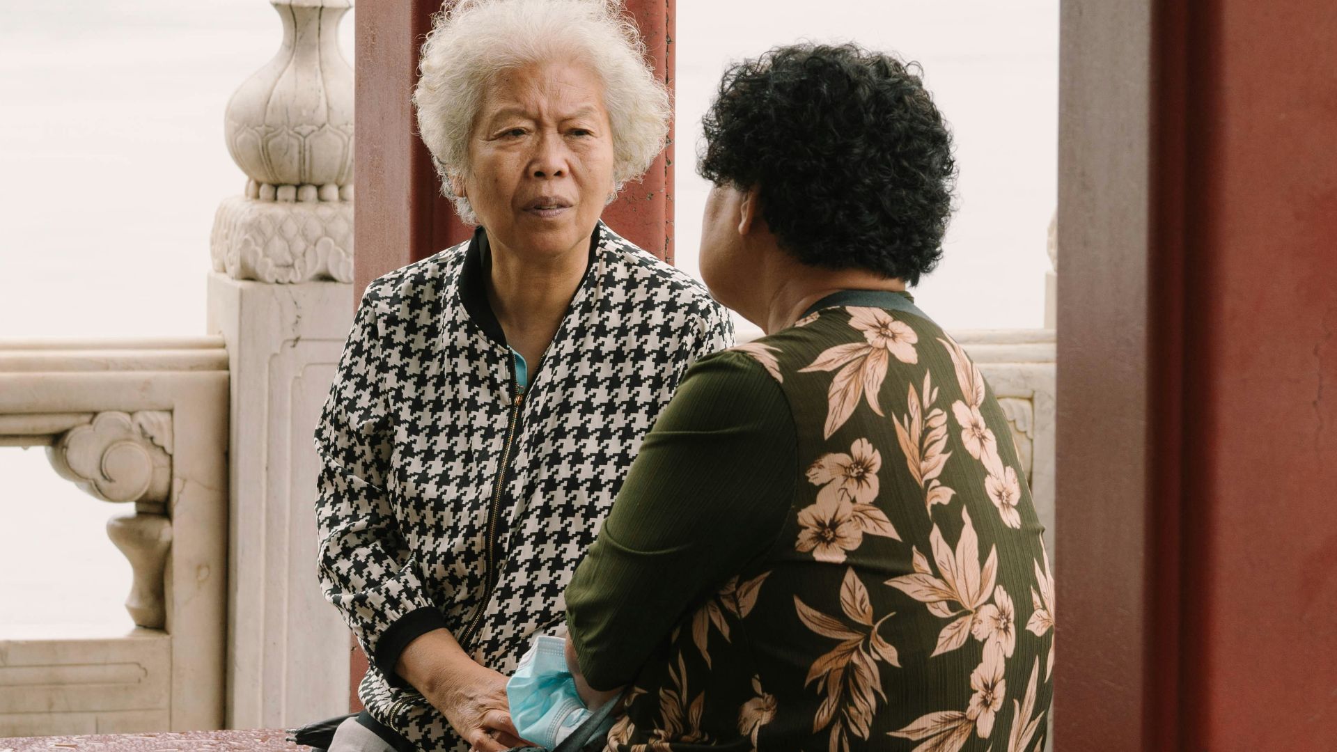 a man and woman sitting on a bench