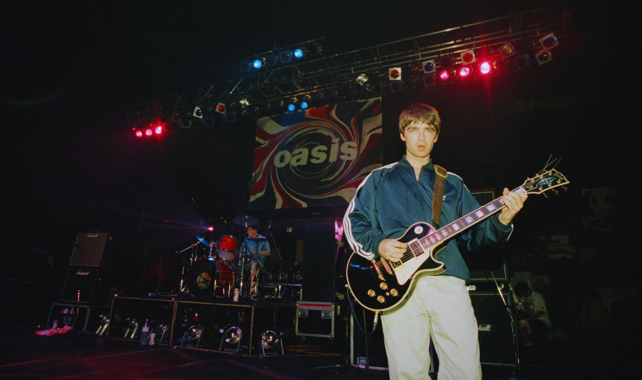 Gettyimages - 97767675, Oasis At The Astoria Noel Gallagher of British rock group Oasis live at the Astoria in London, 19th August 1994. 