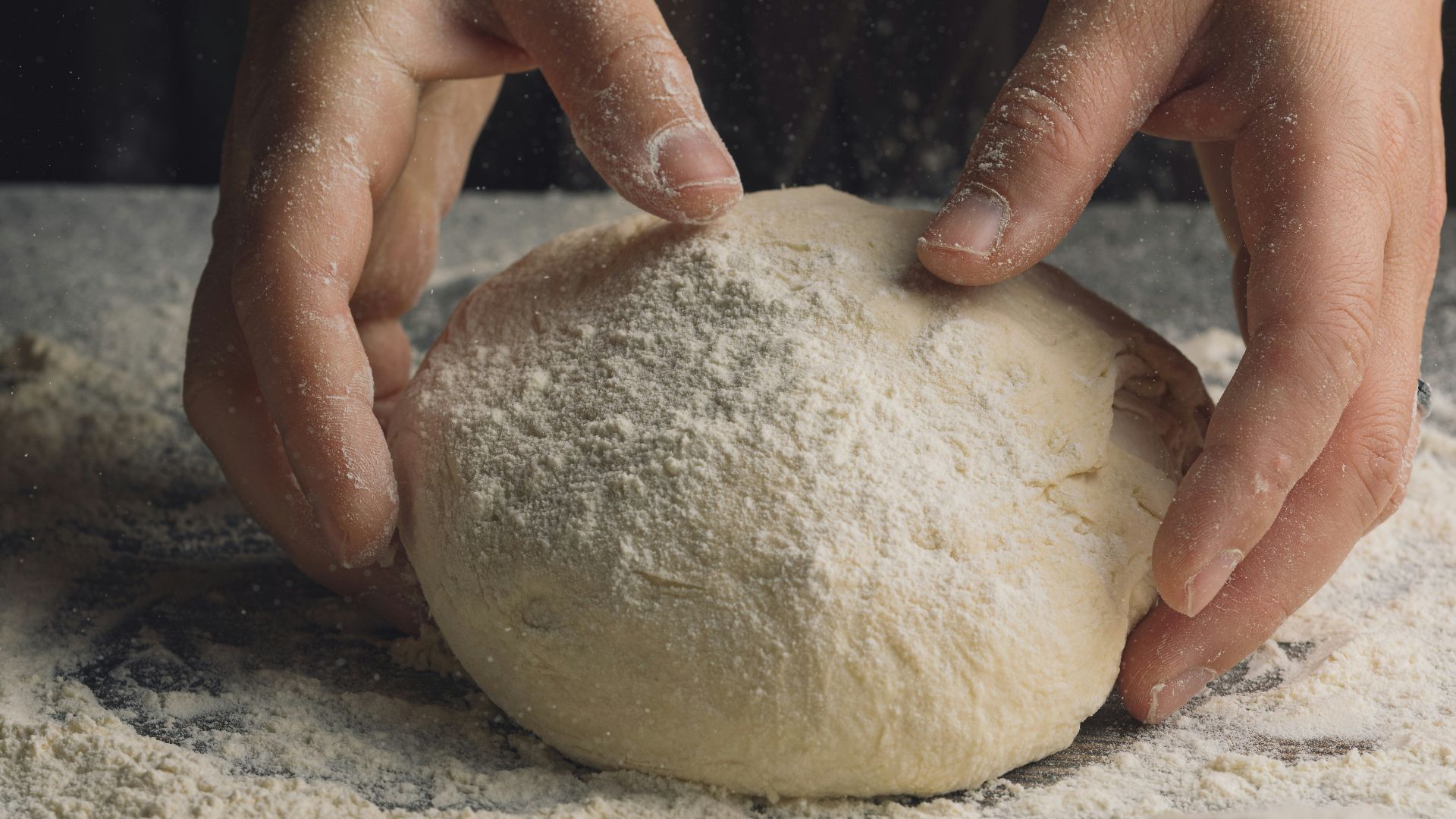 a pair of hands holding a rock