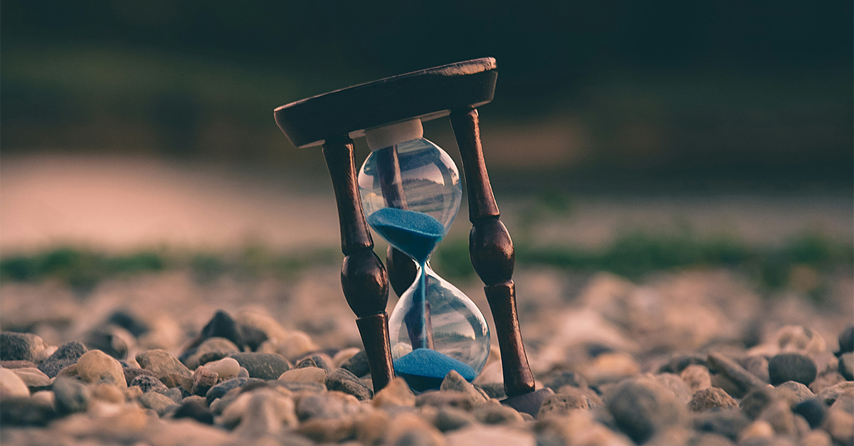 hourglass on a rocky beach