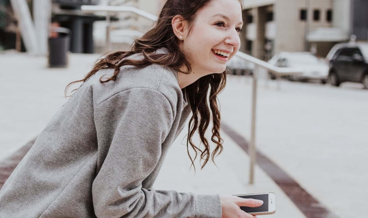 Woman Sits On Sidewalk