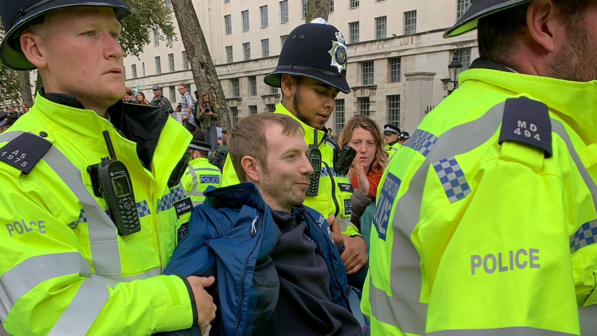 four policemen carrying men