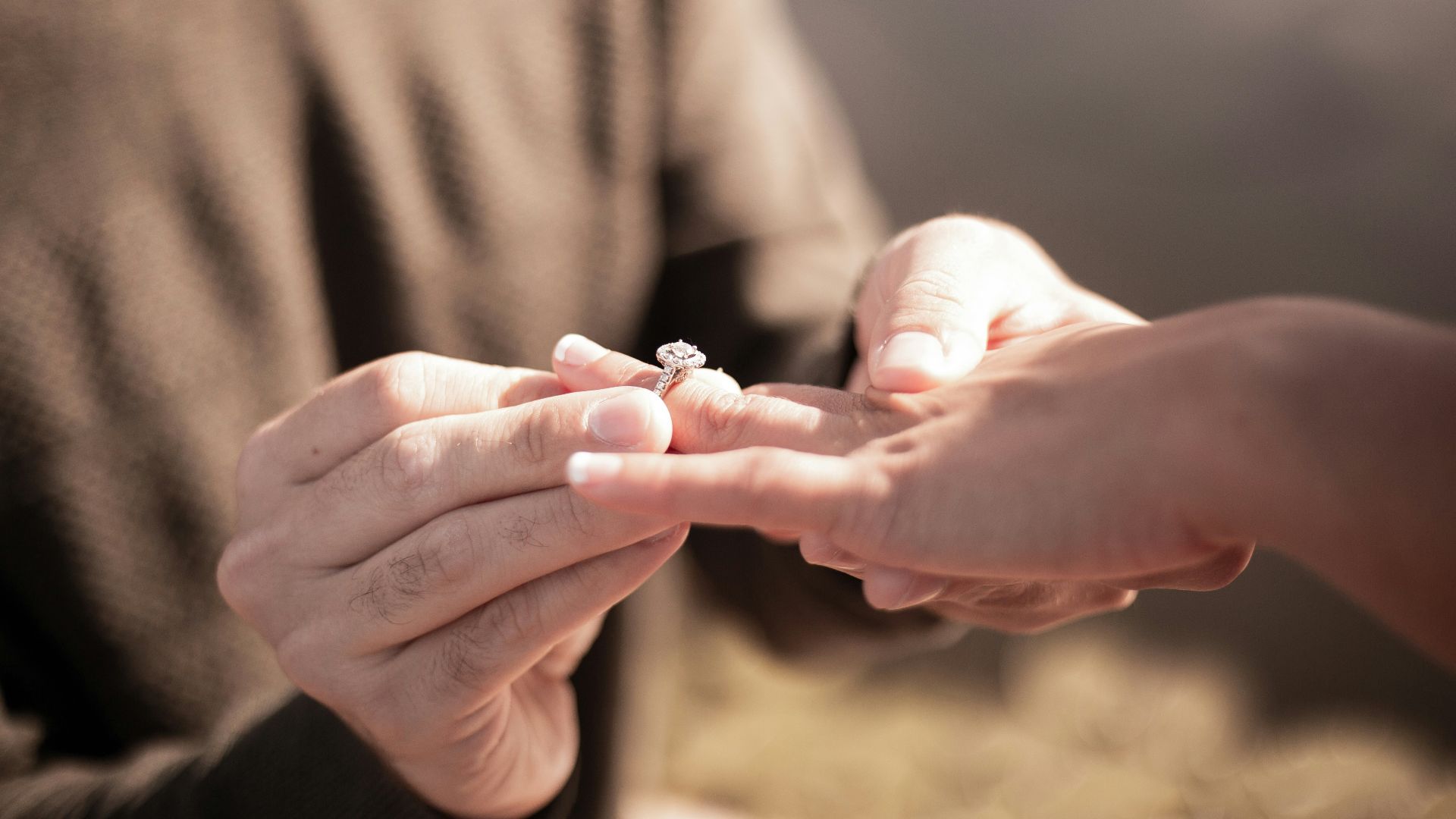 person holding silver diamond ring