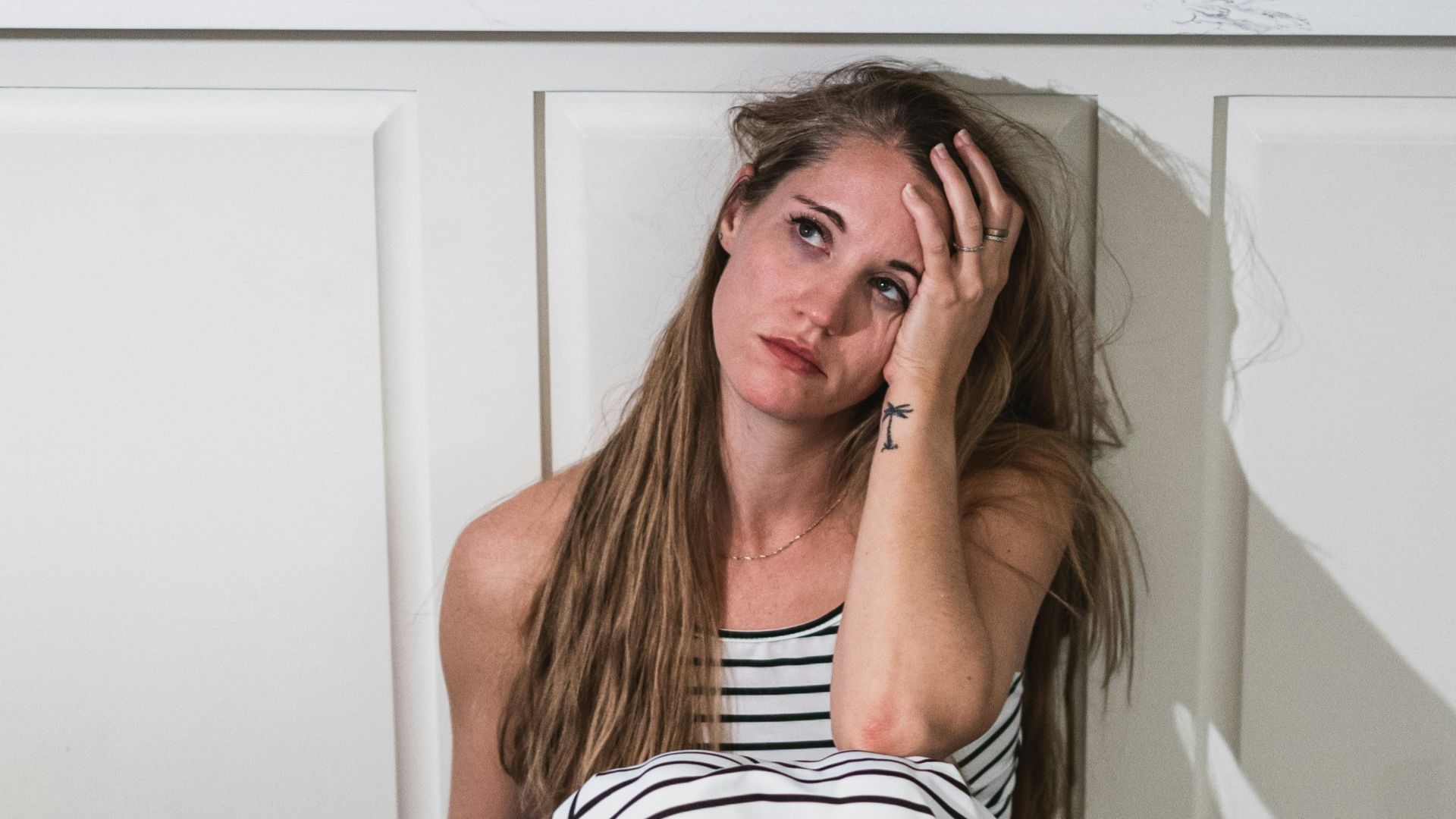 woman in black and white stripe dress holding wine glass
