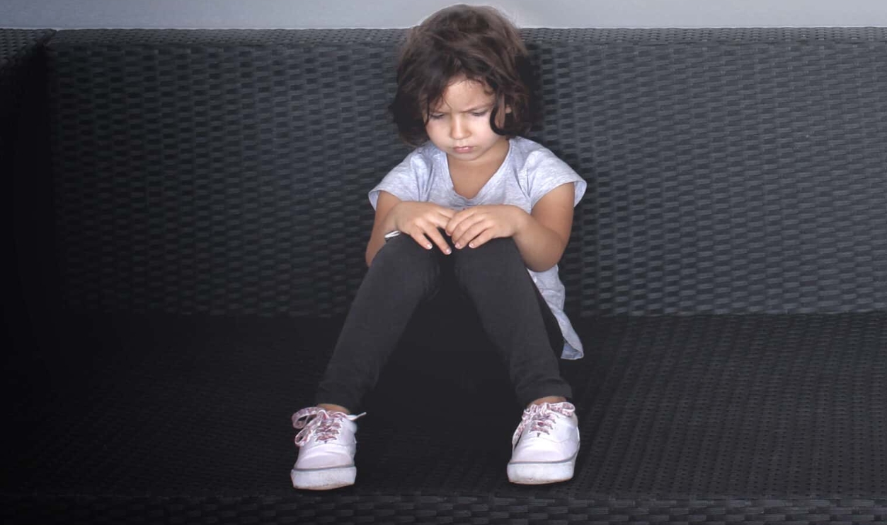 Sulky Young Kid On The Couch