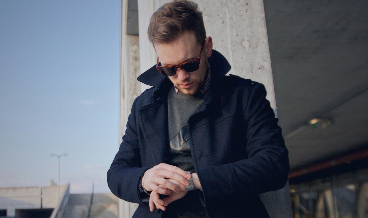 Man Wearing Black Coat Looking At Watch