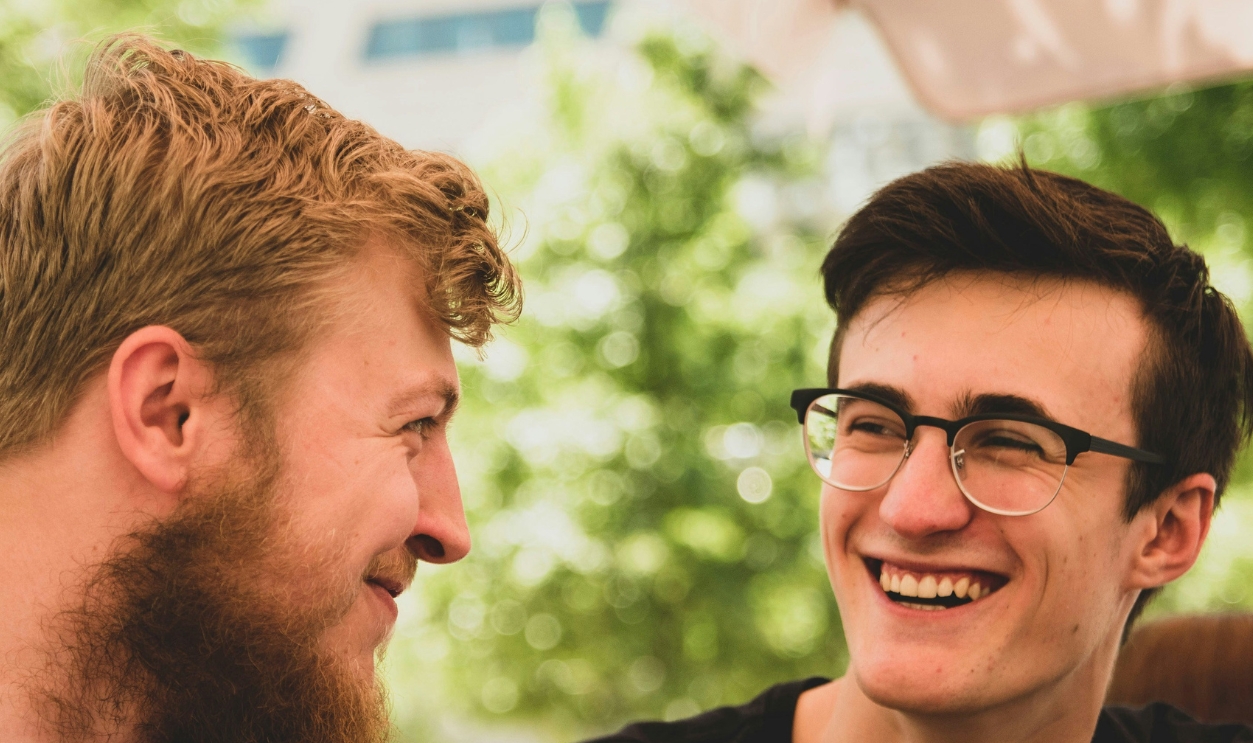 Two Men Smiling Near Trees