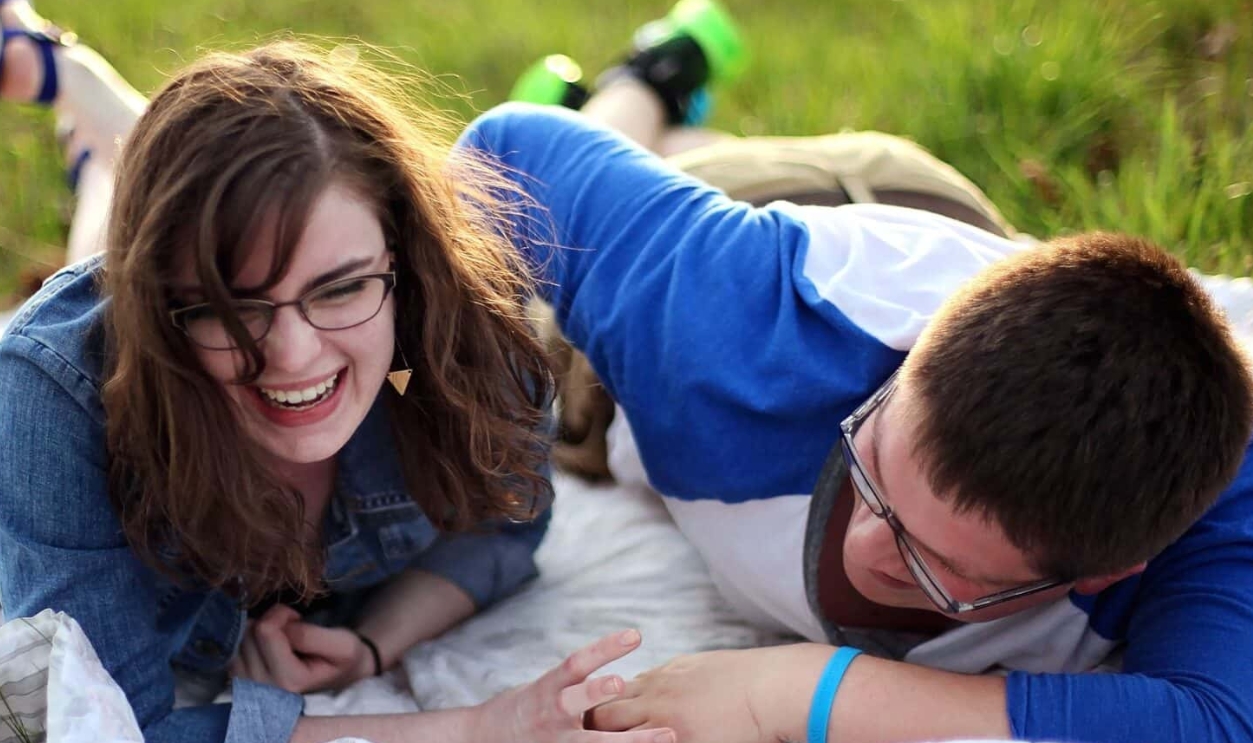 Two Person Laying On White Mat