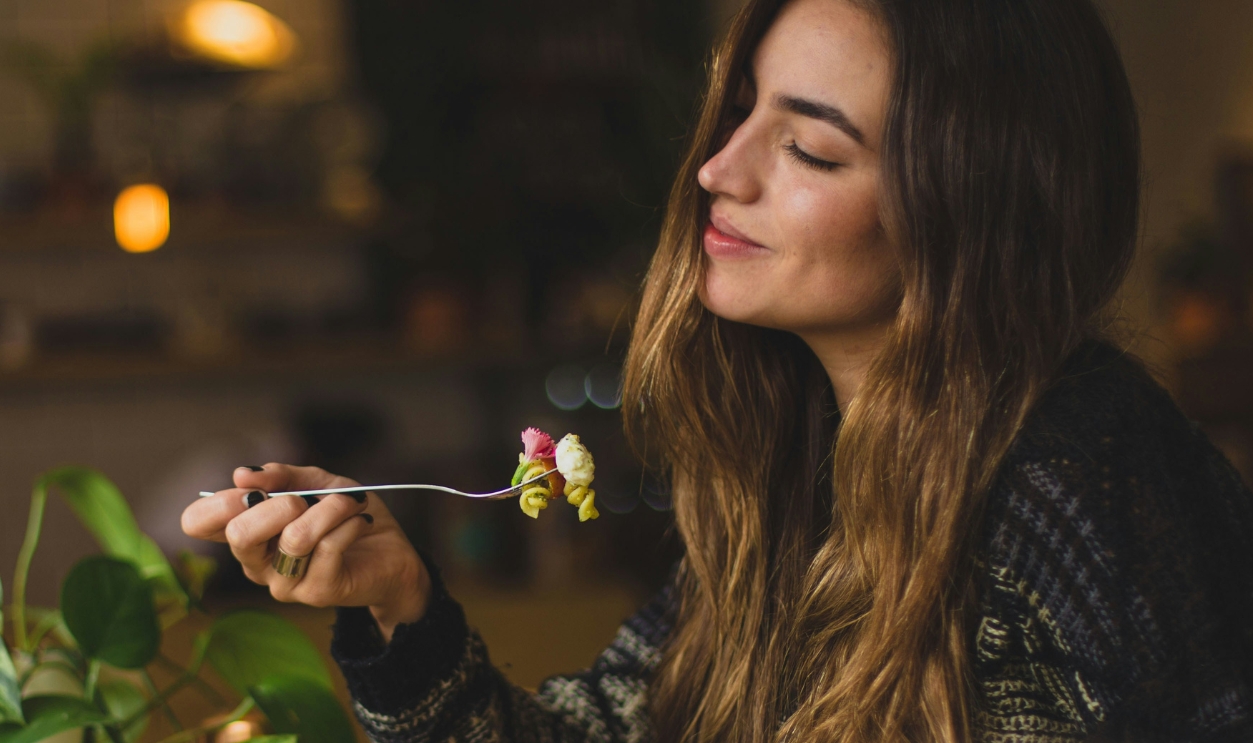 Woman Holding Fork In Front Table