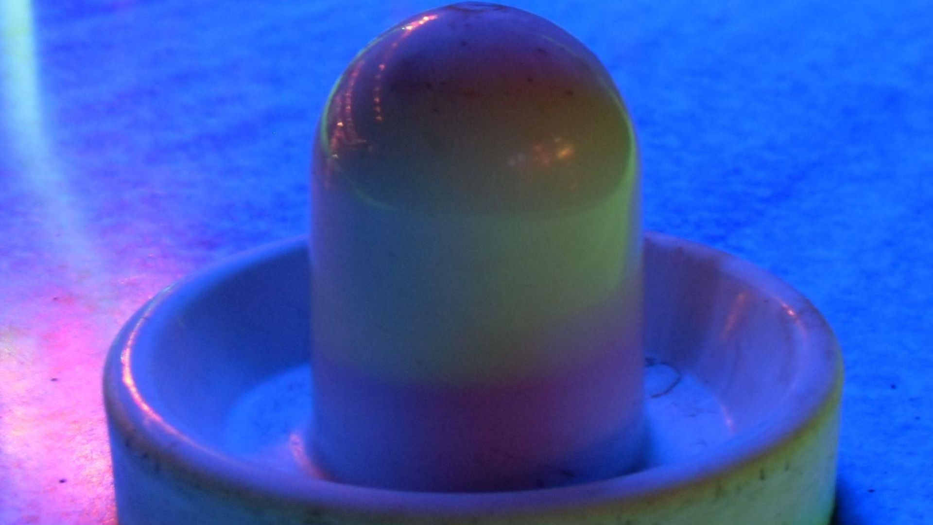 File:Air hockey table and mallet at arcade with neon lighting.jpg