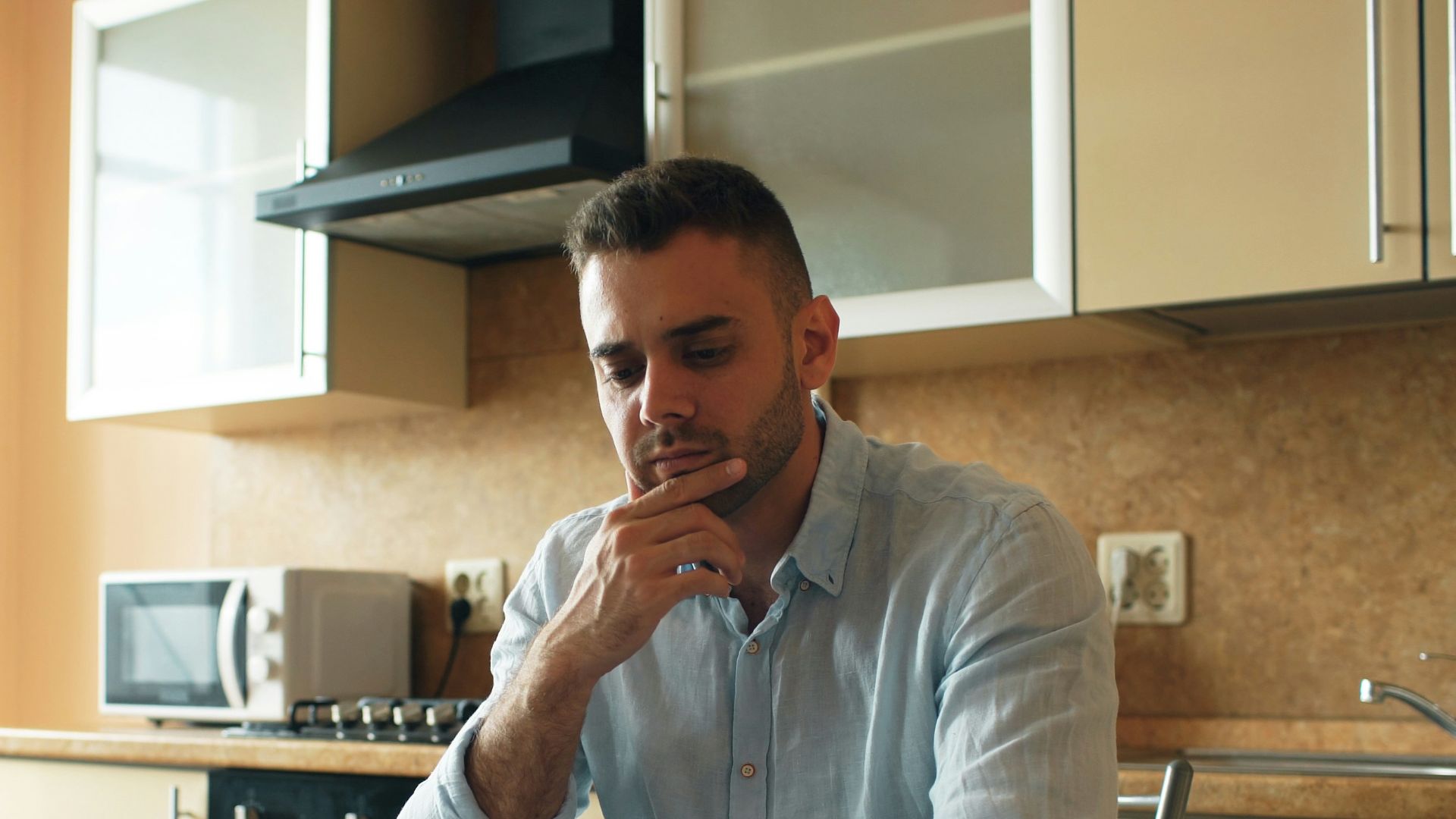Man reading a document in a kitchen