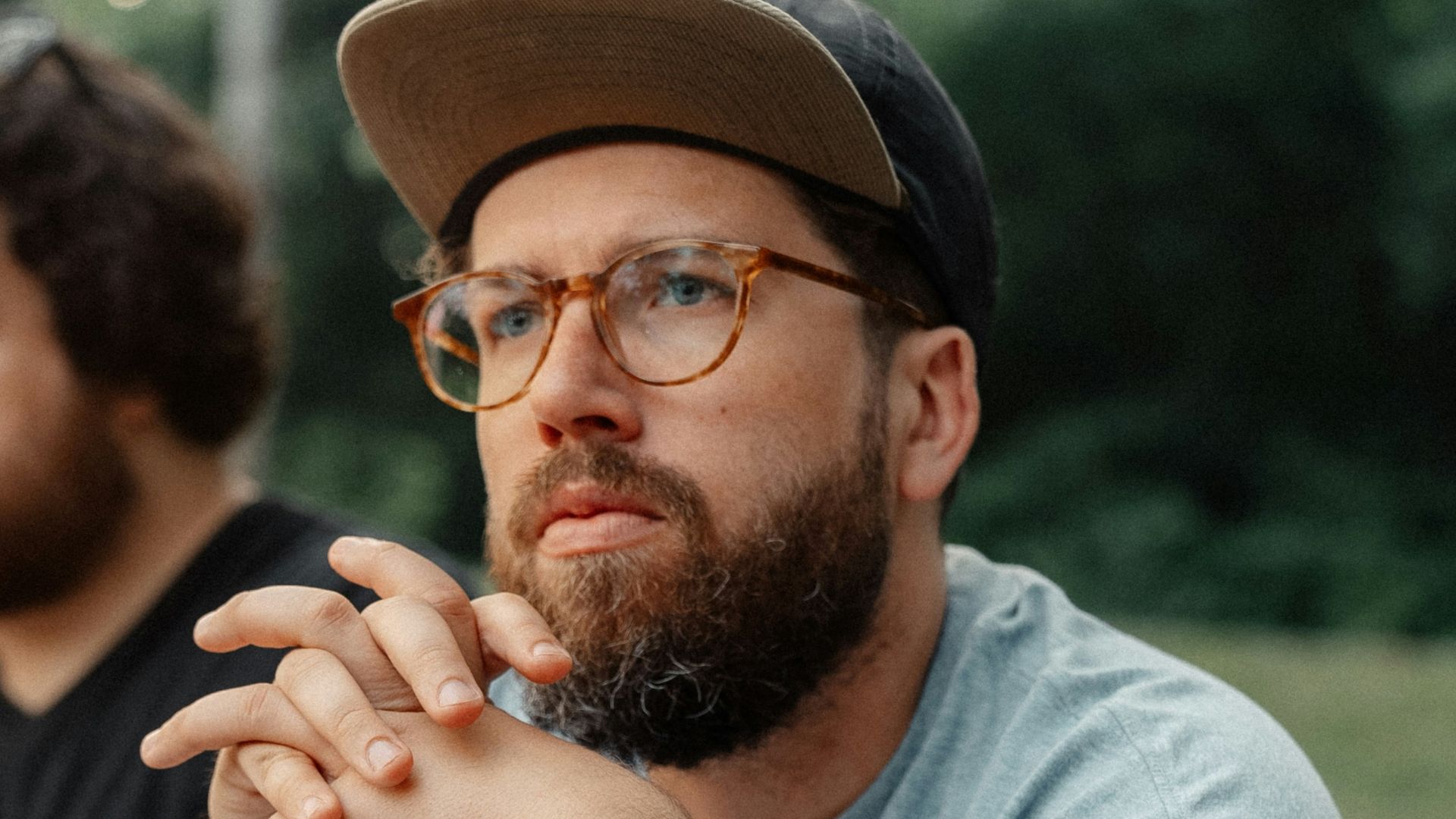 a man sitting at a picnic table with a plate of food