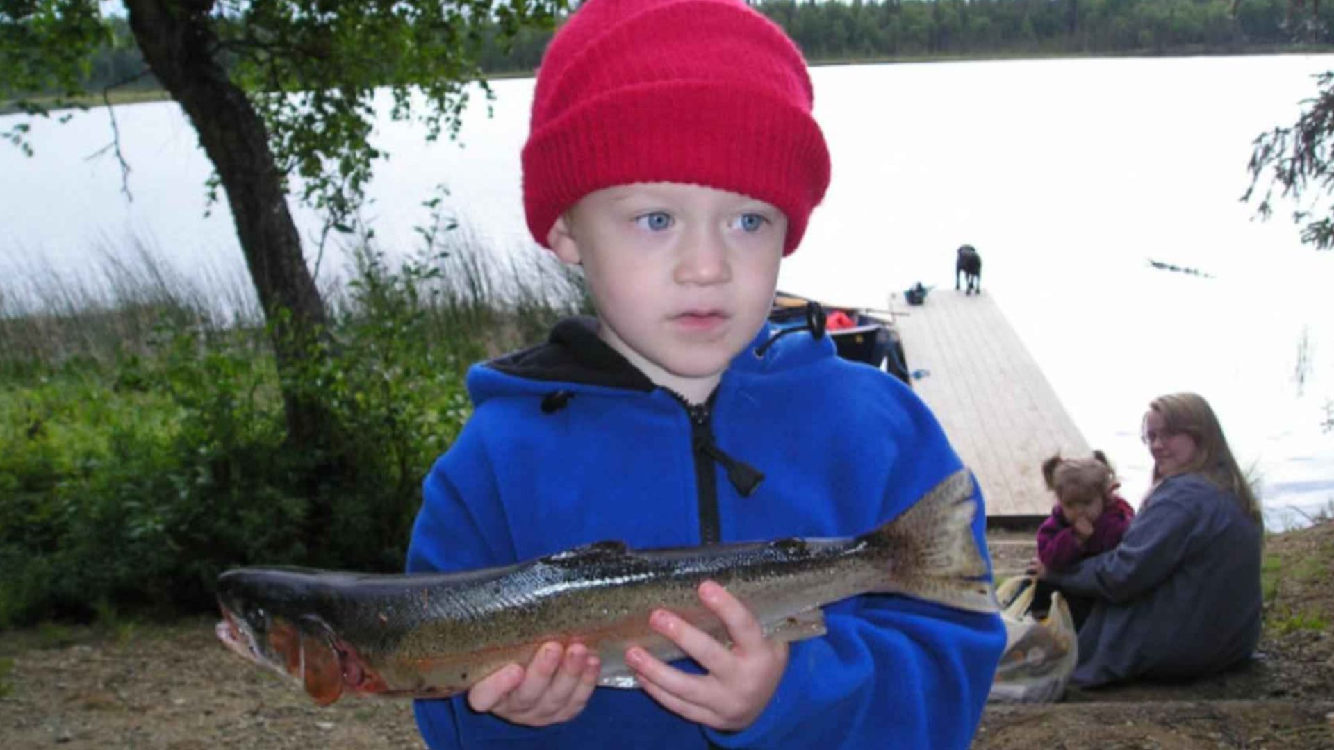 File:Young cute boy with fish in his hands.jpg