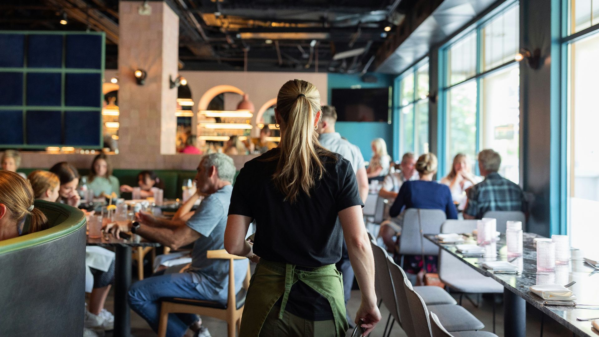A group of people sitting at tables in a restaurant