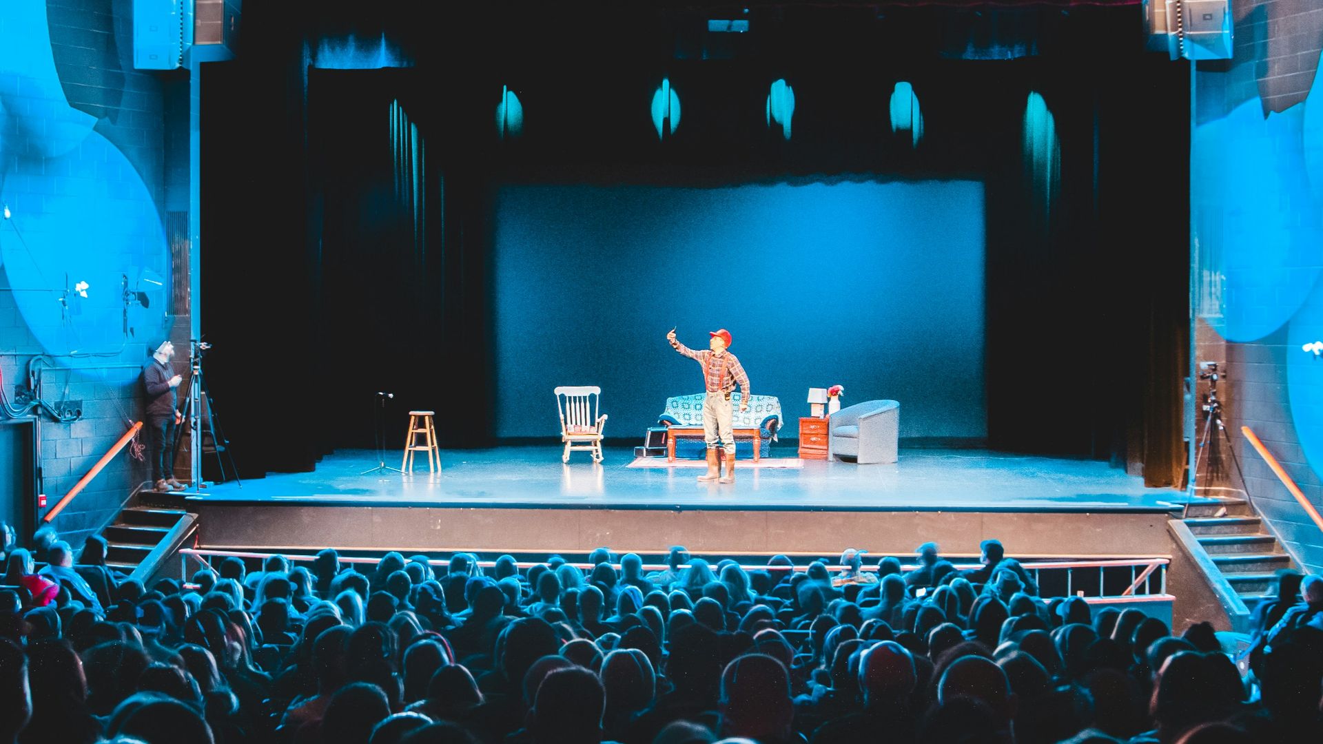 people standing on stage with lights turned on during nighttime