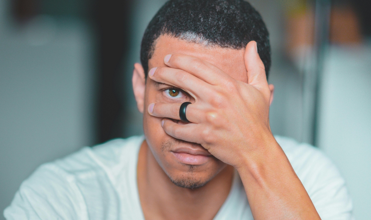 Man Covering His Face