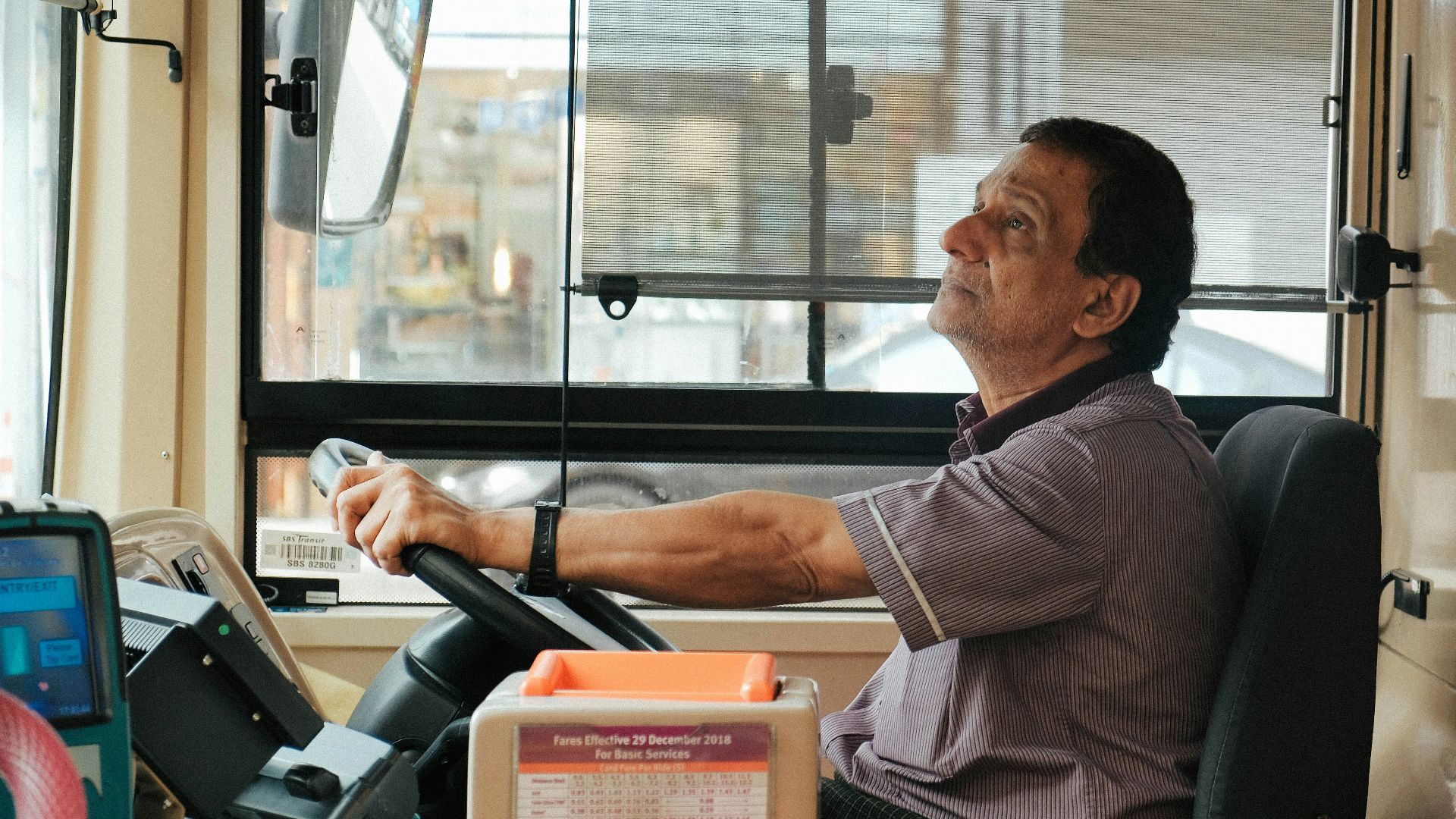 man in brown and white plaid button up shirt sitting on black office rolling chair