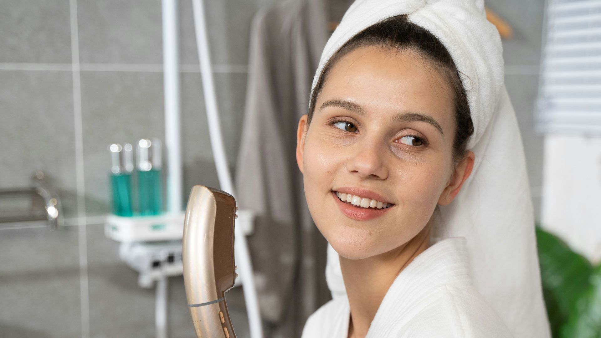 a woman in a bathrobe holding a hair brush