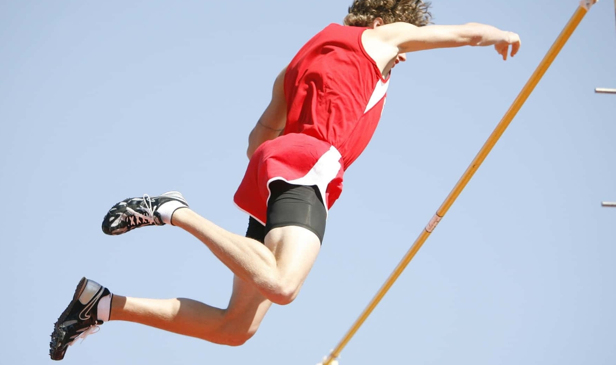 Athlete Jumping Over The Rod