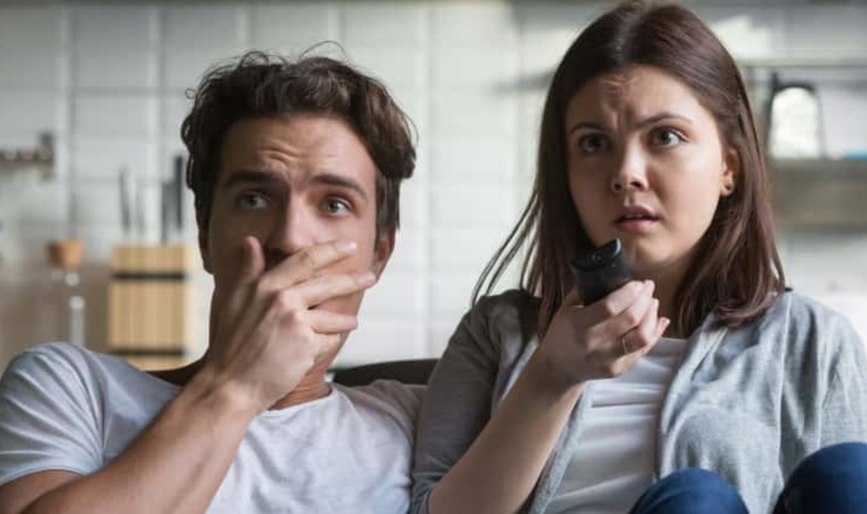 Scared Millennial Couple Watching Horror Movie, Shutterstock, 1095874367