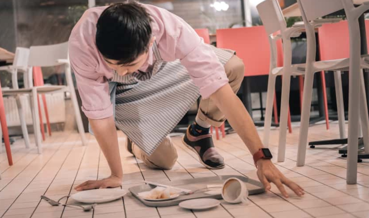 Waiter Cleaning The Floor After Dropping Tray, Shutterstock, 1245505432