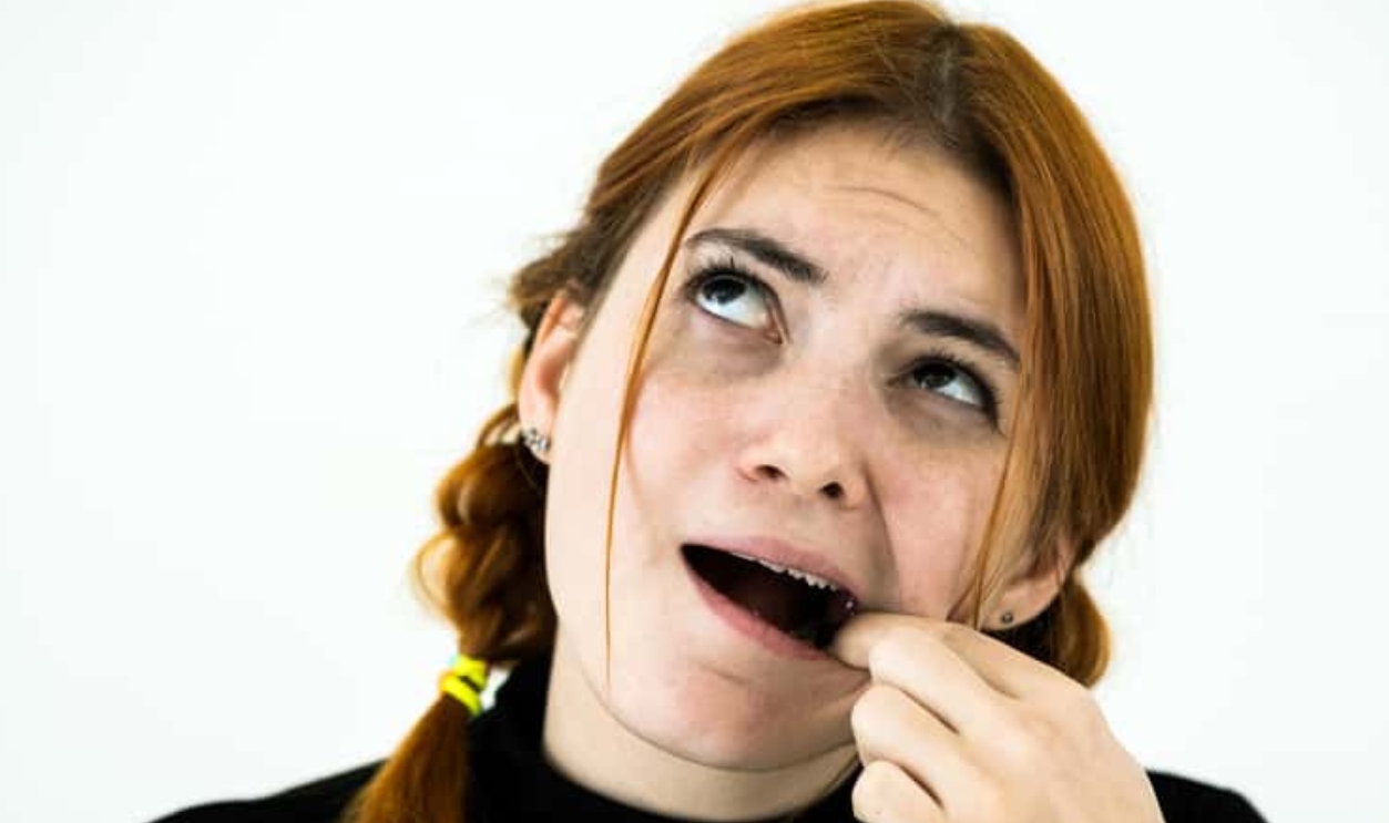 Woman Digging With Her Fingers For Something Stuck In Teeth, Shutterstock, 1696931380