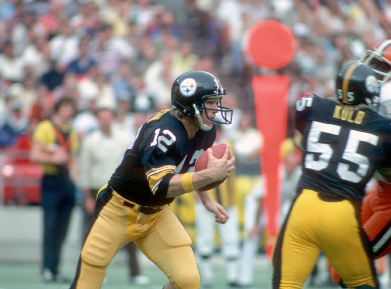 Quarterback Terry Bradshaw #12 of the Pittsburgh Steelers runs with the football