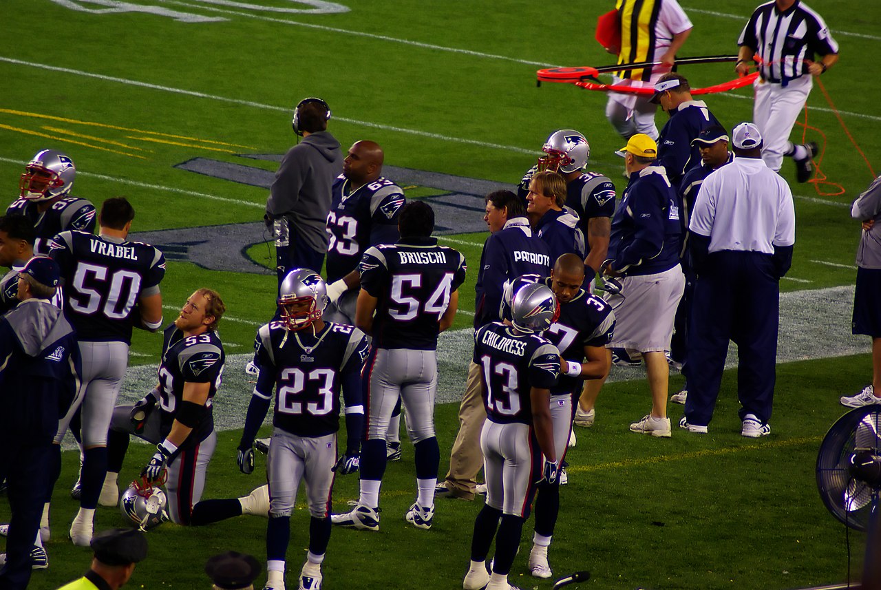 New England Patriots players on sideline during preseason game