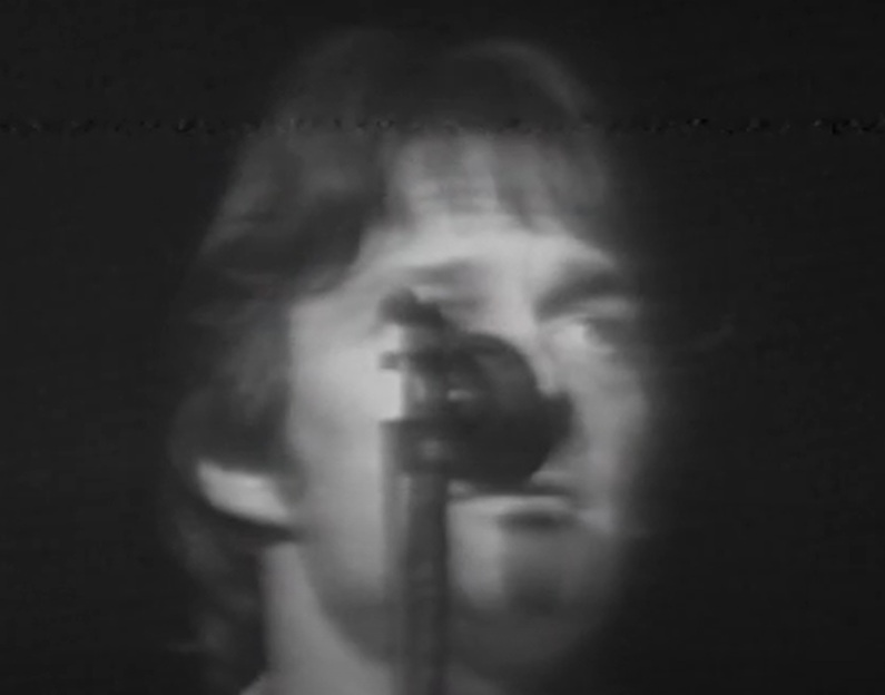 A visually captivating still taken from a pivotal moment in the Concert Gene Clark & Roger McGuinn