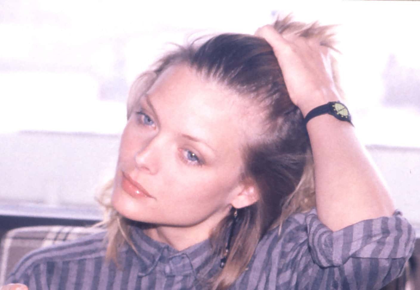 Portrait Photo of American actress Michelle Pfeiffer in purple outfit