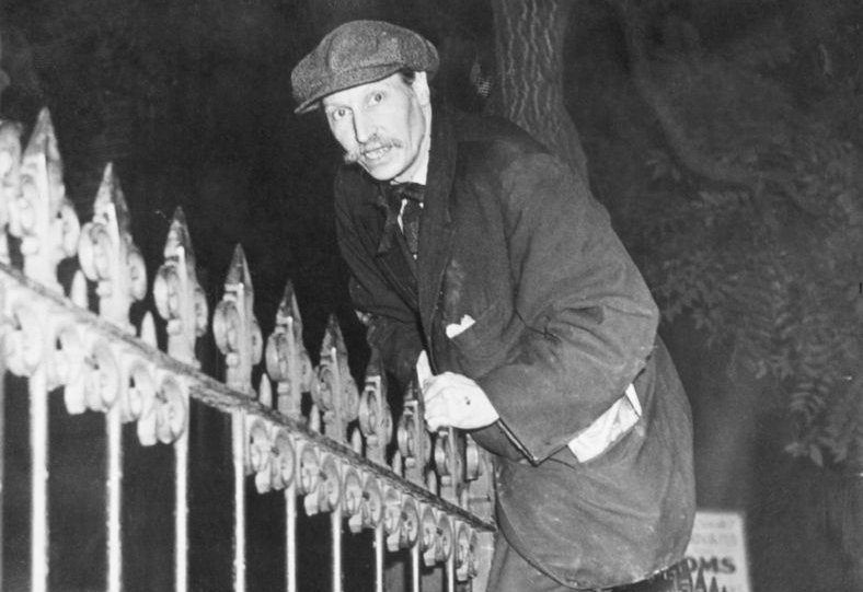 New York recluse Langley Collyer, caught climbing over a fence