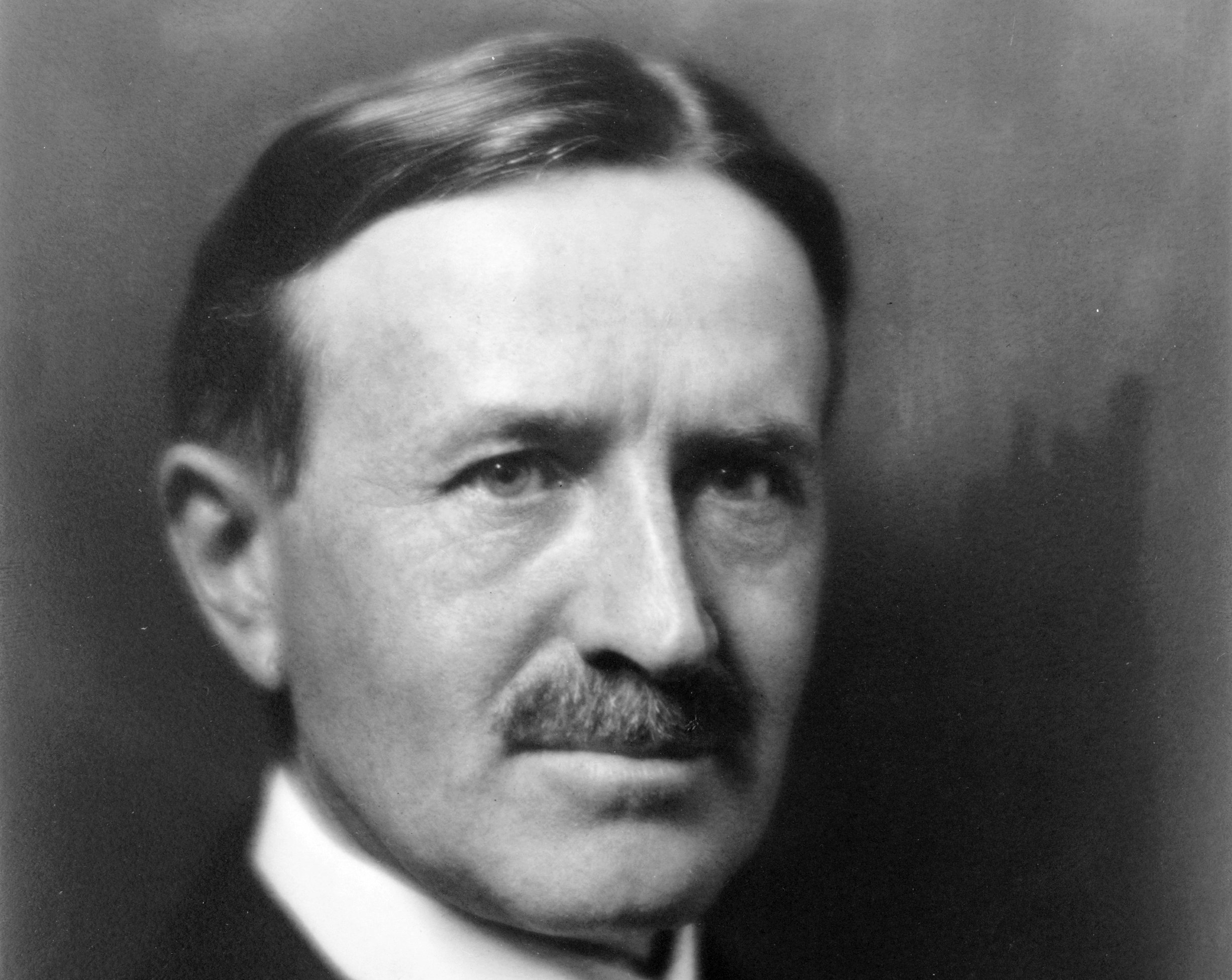 Grayscale Portrait Photo of Harvey Samuel Firestone Sr. facing the camera