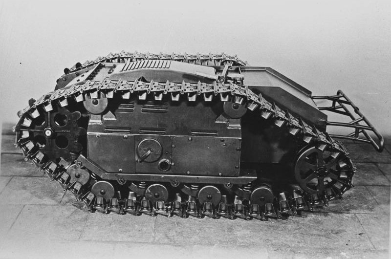 The Goliath tracked mine near a white wall